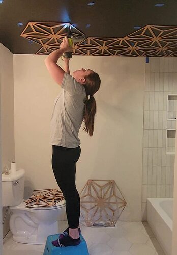 wood-ceiling-with-decorative-wood-pattern-on-black-ceiling-in-bathroom-713x1024