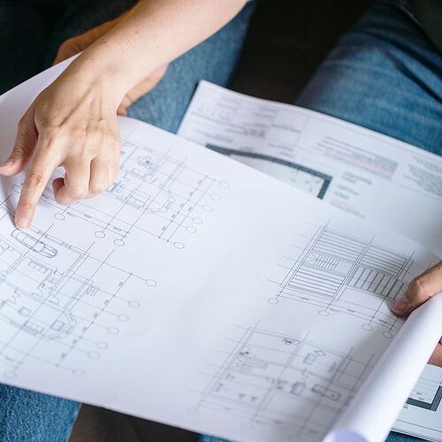 collaborating-on-architectural-blueprint-plans-for-royalty-free-image-1757441569.pjpeg