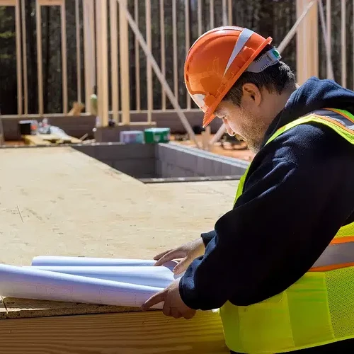 contractor-reviewing-building-plans-and-permit-documents-800x800